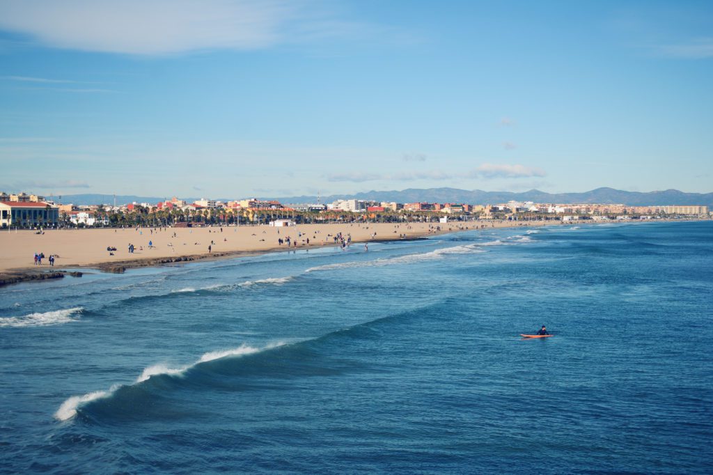 A lone surfer and the view down Playa Malvarossa © PAUL KNOWLES / VALENCIA LIFE